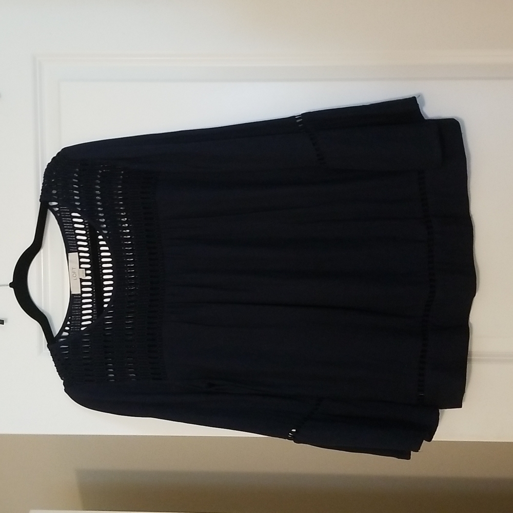 Navy blouse with bell sleeve and cutout detail.